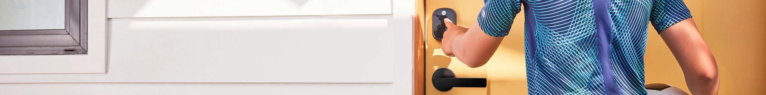 A person entering a code into a lock on a door
