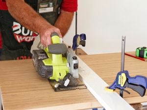 Person cutting a benchtop with a power saw