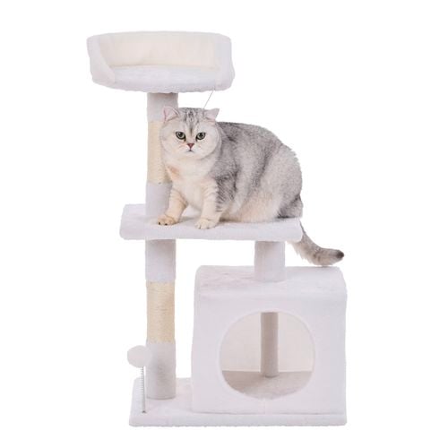 A cat standing on a 2 tier cat playhouse.
