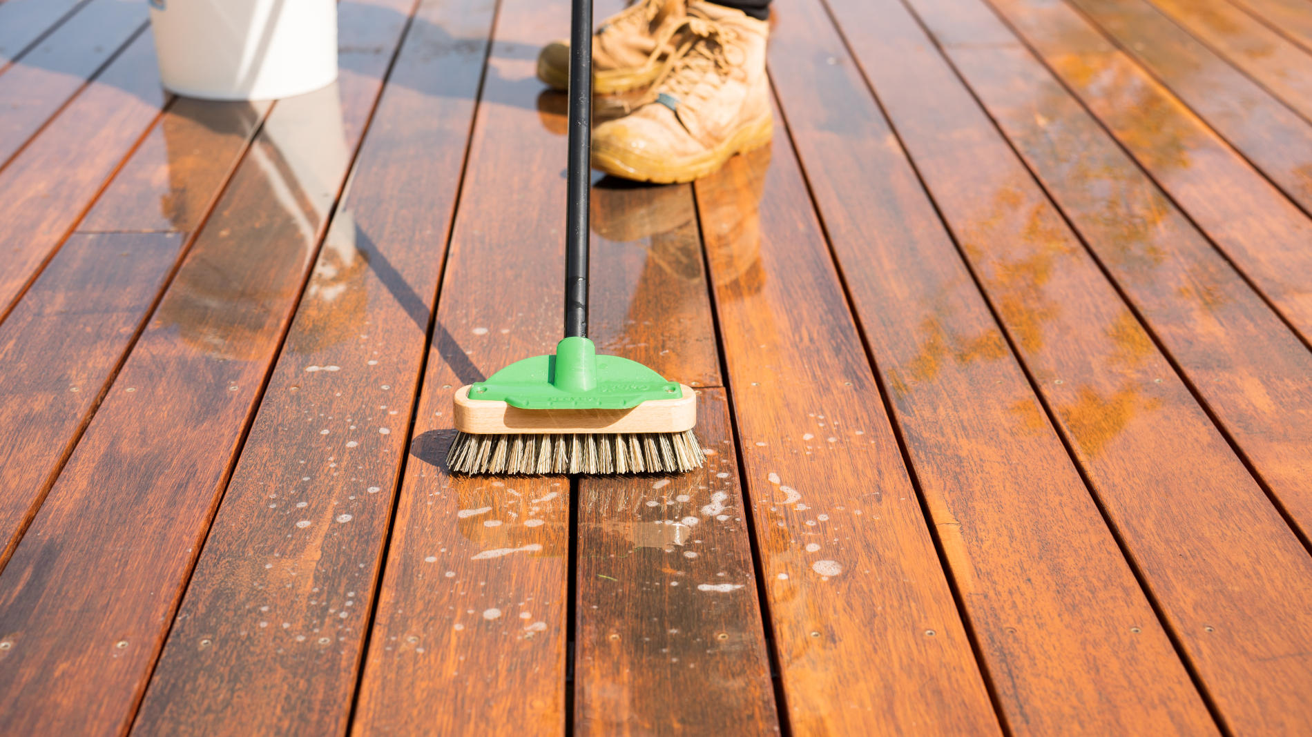 Person scrubbing a deck