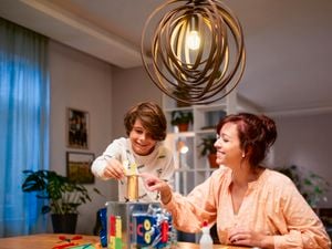 Mom and son building a castle under light