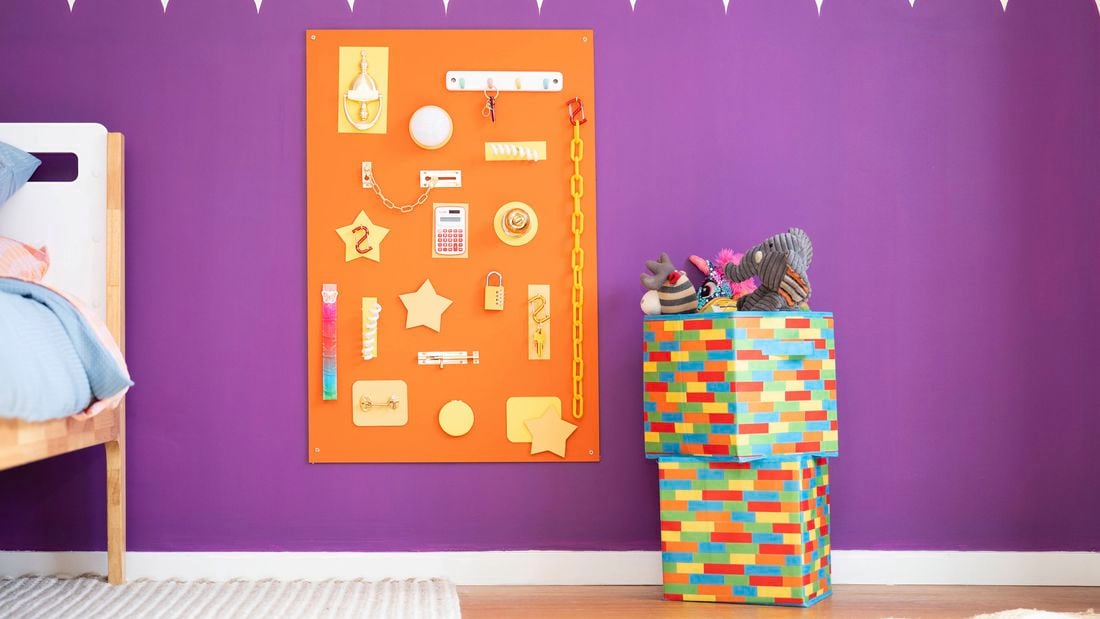 Colourful DIY busy board with interactive hardware pieces