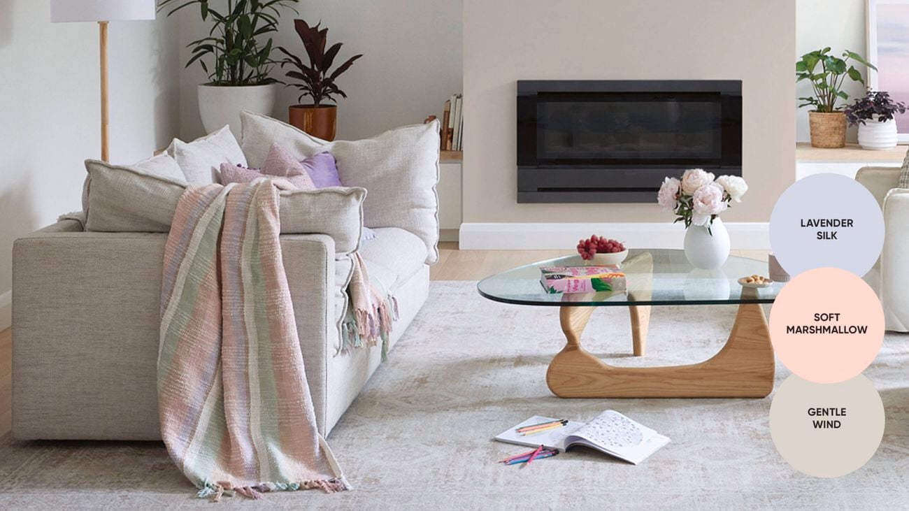 Loungeroom with white couches and timber furniture and white walls painted in British Paints Gentle Winds.