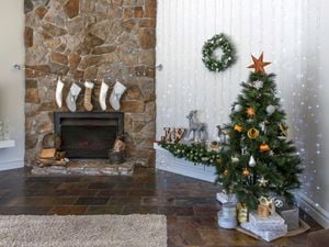 Country style lounge room with Christmas tree, fireplace and christmas lights