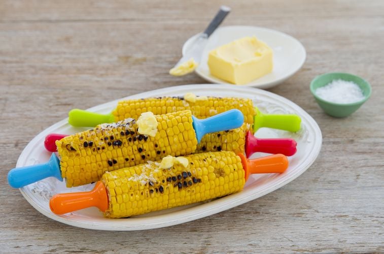 Barbecued corn sitting on a platter