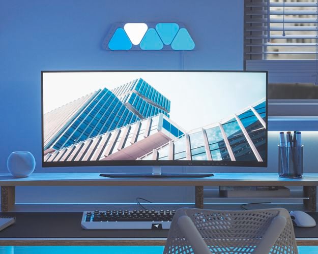 5 smart light panel layout mounted onto a wall behind a desk setup.