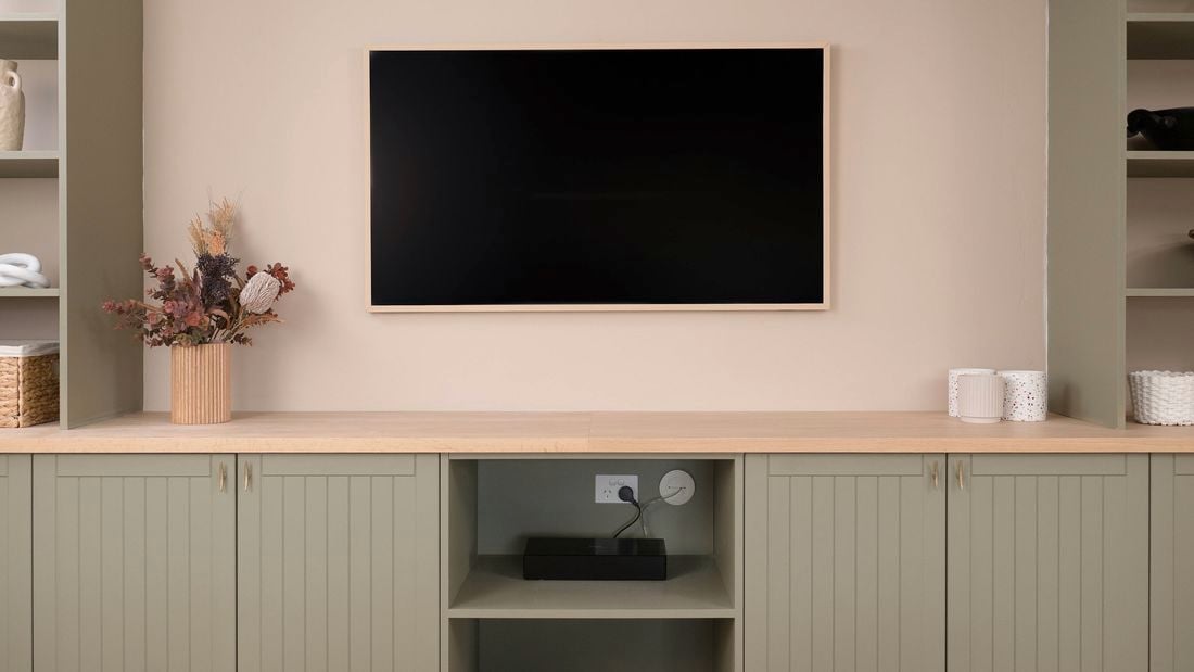 Image of a mounted TV with hidden cables using grommets.