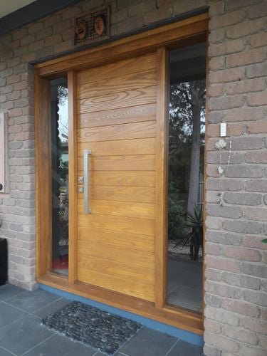 Timber front door to home with large handle