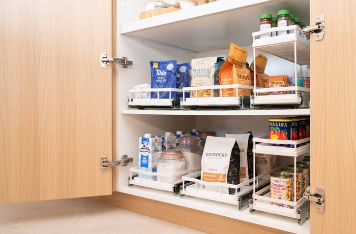 Deep cupboard fitted with pull-out drawers for organised food storage