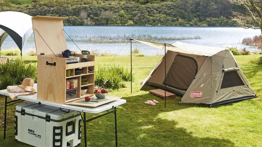 Tent and camping equipment by the river.