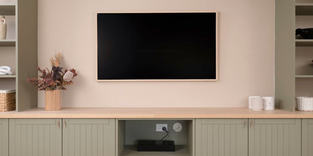 Image of a mounted TV with hidden cables using grommets.