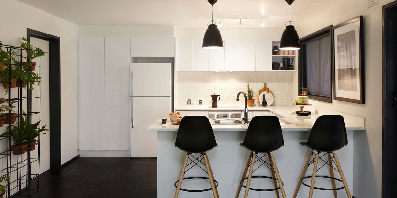 Modern kitchen featuring a lot of white.