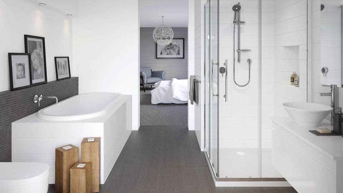 Modern bathroom with a grey and white colour scheme. There is a bath, shower and sink in shot.