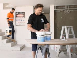 two tradies preparing to paint in a house