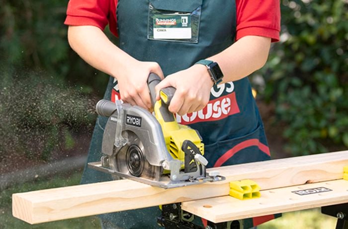 Bunnings team member cutting a piece of timber with a circular saw