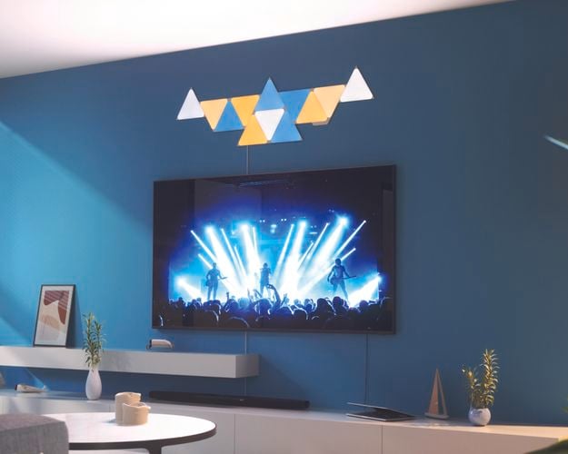12 smart light panel layout mounted onto a wall behind a TV in the living room.