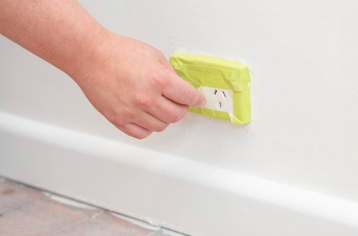 Covering a power outlet with painter’s tape