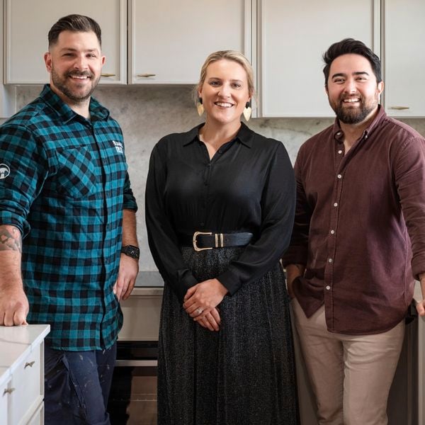 Three people in a modern kitchen.
