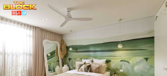 Contemporary bedroom featuring neutral bedding, a green landscape mural, pendant lights, ceiling fan and floor-to-ceiling curtains.
