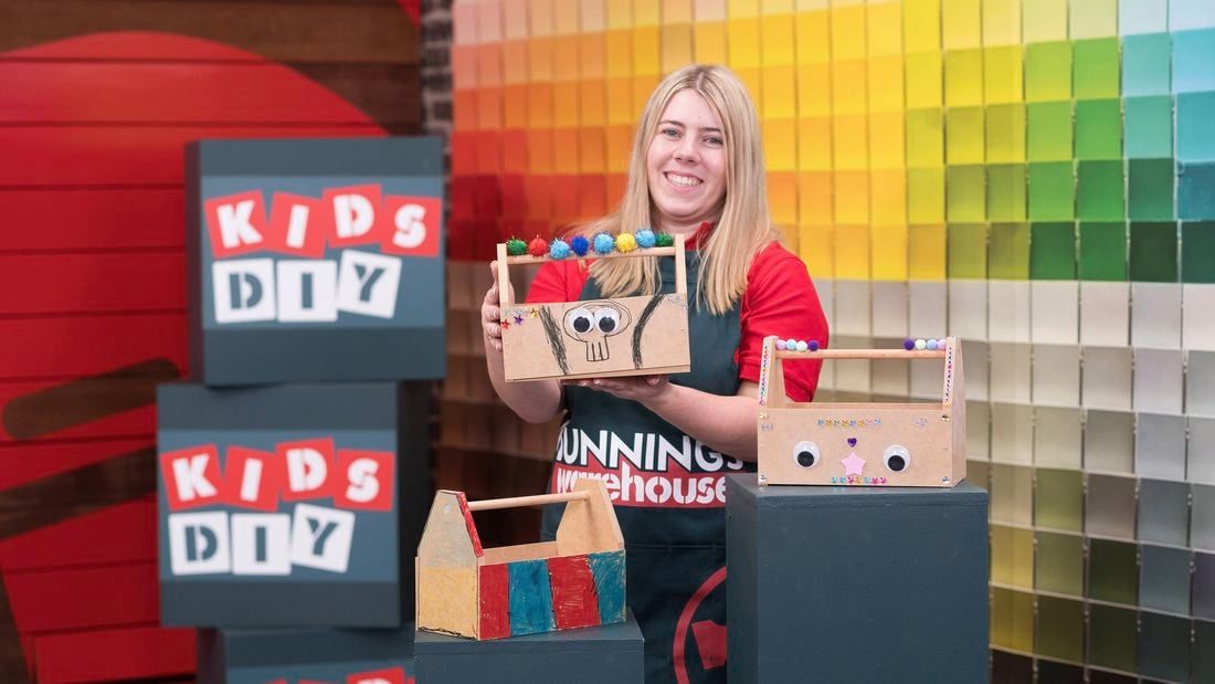 A Bunnings Team Member is holding a decorated tool caddy.