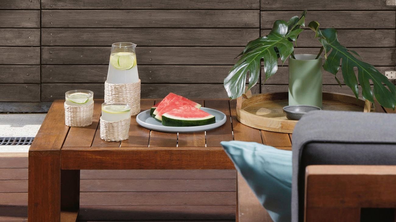 Dining table in outdoor dining area with watermelon and lemonade