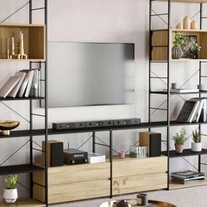 An image of an open entertainment unit made from Flexi Storage Studio Silhouette shelving units in Black and Oak, with Oak shelves and two-drawer units in Oak