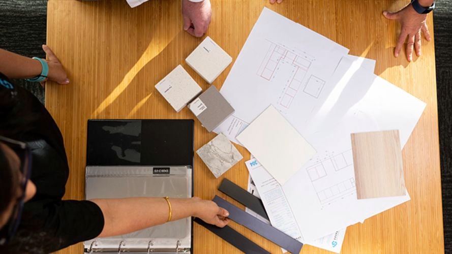 timber table with house plans displayed on it
