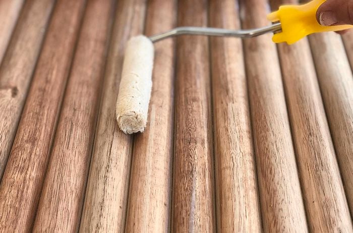 Applying varnish to dowel using a mini roller