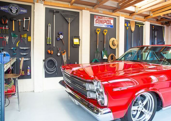 Garage featuring Pinnacle pegboards and a variety of pegboard hooks.