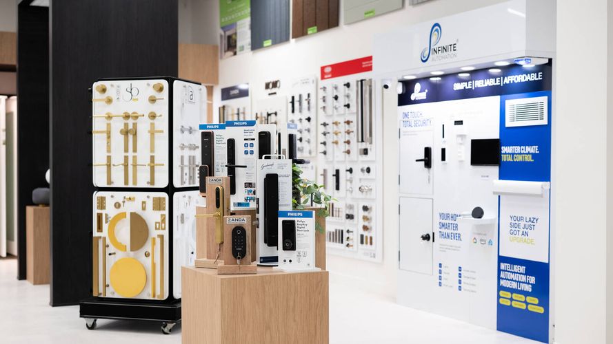 Showroom display featuring smart locks, door hardware, security products and home automation solutions mounted on demonstration panels.