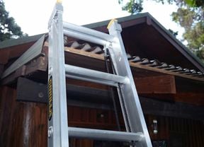 Ladder resting against a corrugated metal roof