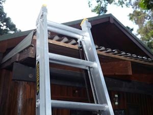 Ladder resting against a corrugated metal roof