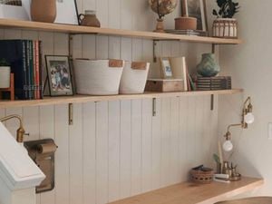 Home office with shelving on the wall