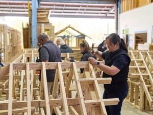 Several carpentry trade students work on frame and truss structures at Holmesglen Institute.