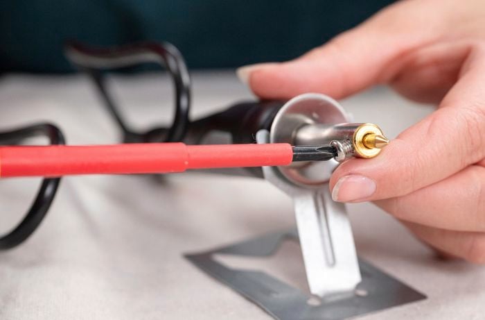 Adjusting the soldering iron.