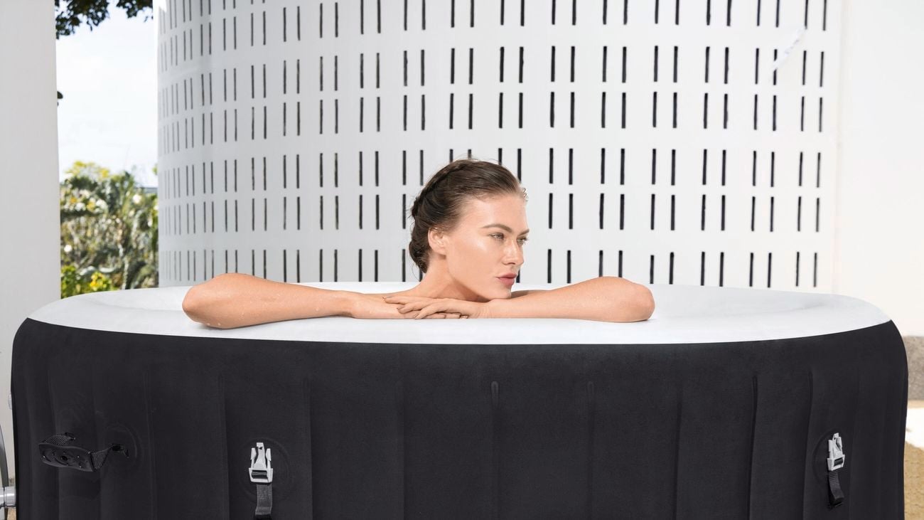Woman sitting in spa resting on her forearms