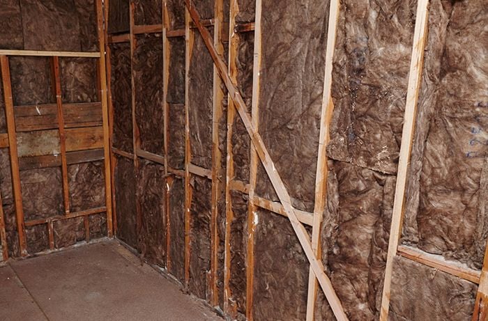 An indoor room with bare walls lined with insulation