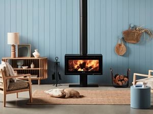Indoor wood heater in a styled living room.