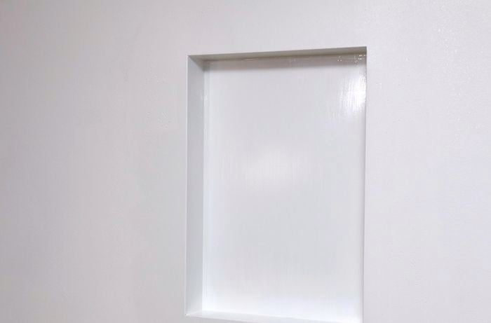 A rectangular niche in a white wall
