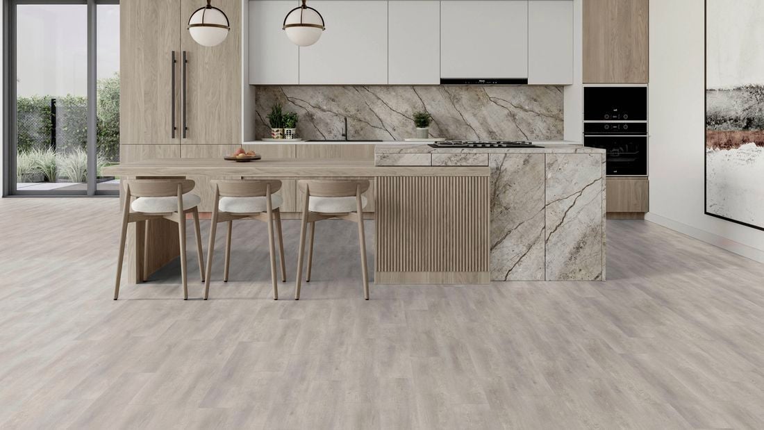 Modern kitchen with vinyl flooring, light wood cabinetry, a large island with seating, marble splashback and pendant lights.