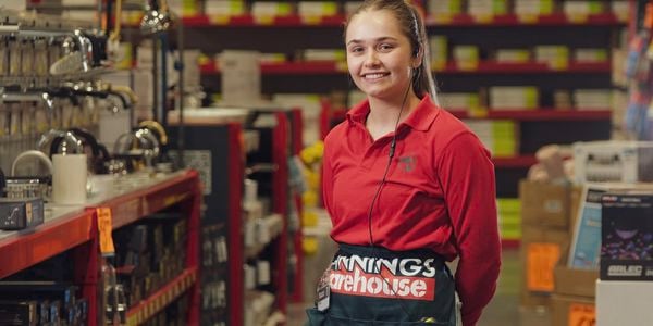 Team member in the tap aisle smiling. 