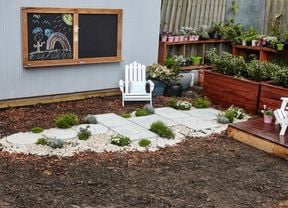 Hopscotch court made from concrete pavers in a backyard