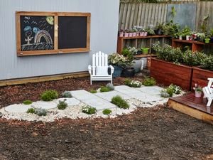 Hopscotch court made from concrete pavers in a backyard