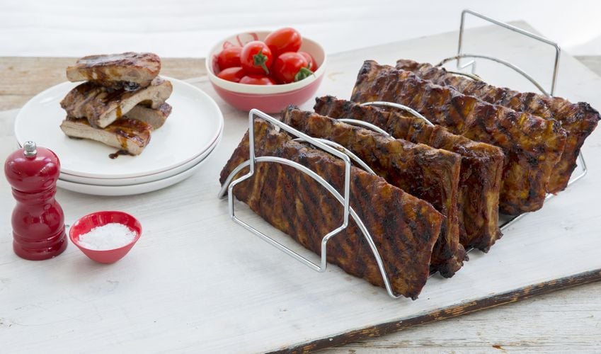 Racks of ribs sitting in stainless steel rack