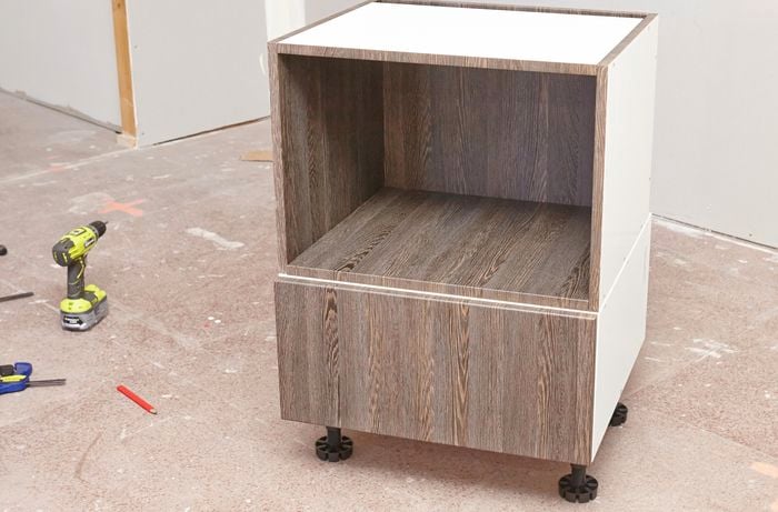 An assembled cabinet on adjustable legs