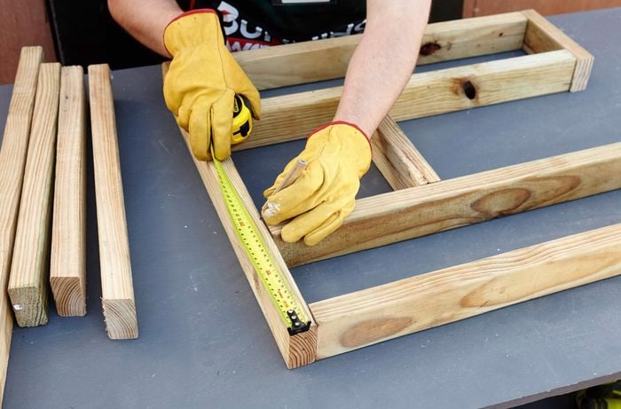 Person measuring timber.