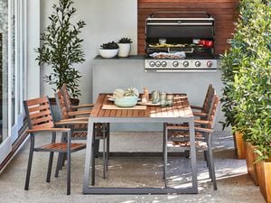 An outdoor dining setting with an in-built gas-powered barbecue