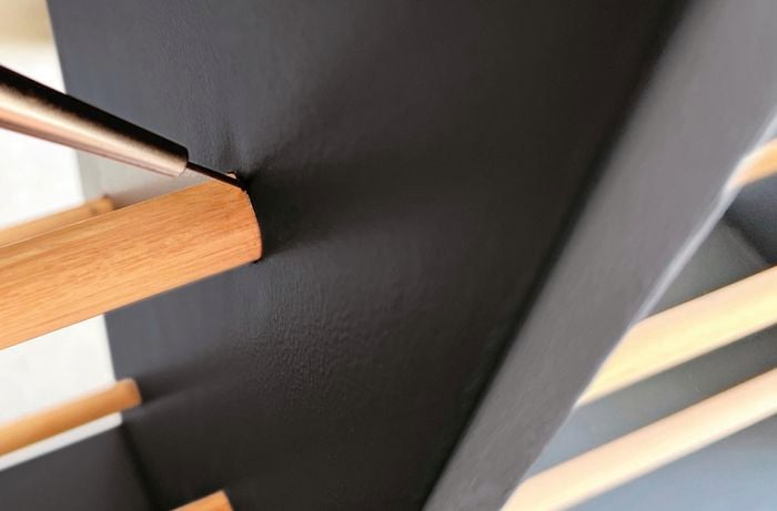 Close up picture of rungs attached to sides of a shoe rack.