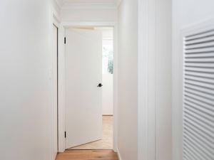 A fully installed door opens easily within the frame, indicating correct fitting and secure hinge installation.