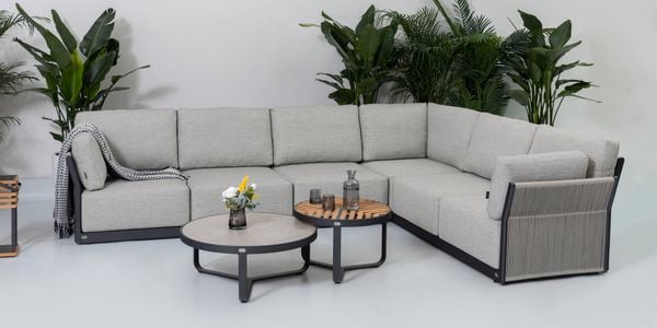 Outdoor L shaped couch set with side table in outdoor backyard setting